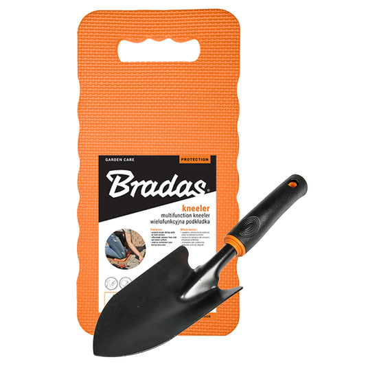 Black wide hand trowel beside an orange Bradas foam kneeling mat with a carry opening.